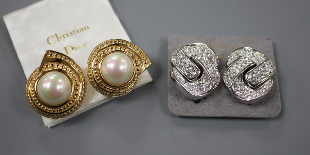 Two pairs of Christian Dior costume ear clips, white paste and simulated pearl, both approx. 33mm, both in Dior boxes.